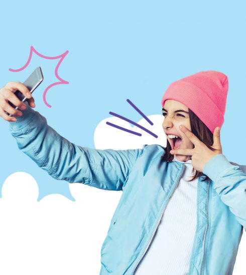 Teenage girl posing with phone, cloud graphics